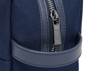 The Littler Dopp Kit: Navy Ballistic - Navy Embroidery, close-up of zipper and strap detailing, showcasing its textured fabric and precise stitching.