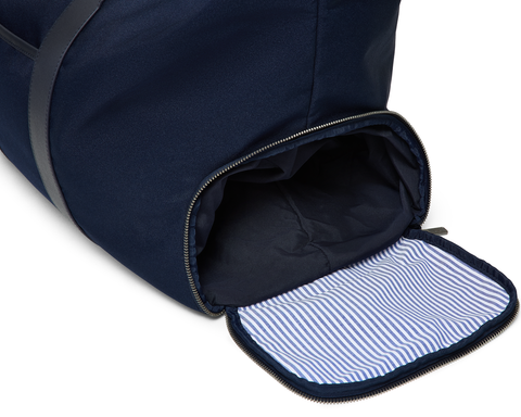 The Byers Duffel Bag: Navy Ballistic features a wide top opening, revealing a waterproof shoe compartment with a light-blue striped lining.