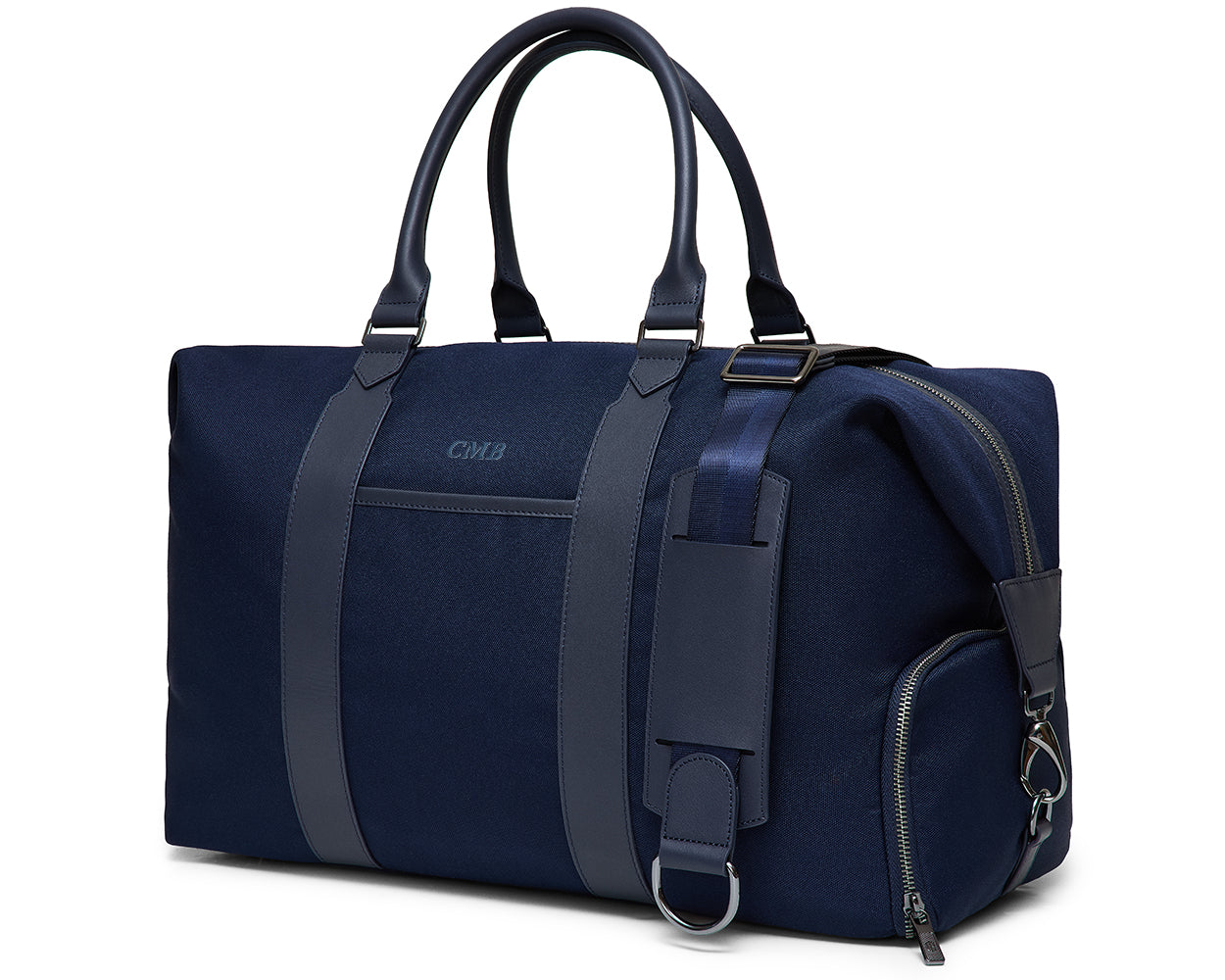 The Byers Duffel Bag: Navy Ballistic - Navy Embroidery, a canvas weekender with leather trim, features monogram CMB, handles, shoulder strap, and multiple pockets.