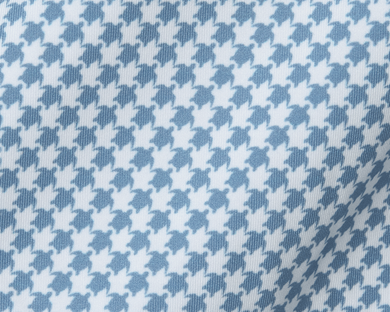 The Kitts Boys Shirt: Bedford, showcasing a blue-and-white woven fabric with a playful turtle print resembling houndstooth, featuring a structured spread collar.