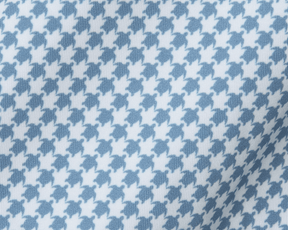The Kitts Boys Shirt: Bedford, showcasing a blue-and-white woven fabric with a playful turtle print resembling houndstooth, featuring a structured spread collar.