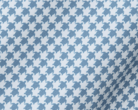 The Kitts Boys Shirt: Bedford, showcasing a blue-and-white woven fabric with a playful turtle print resembling houndstooth, featuring a structured spread collar.