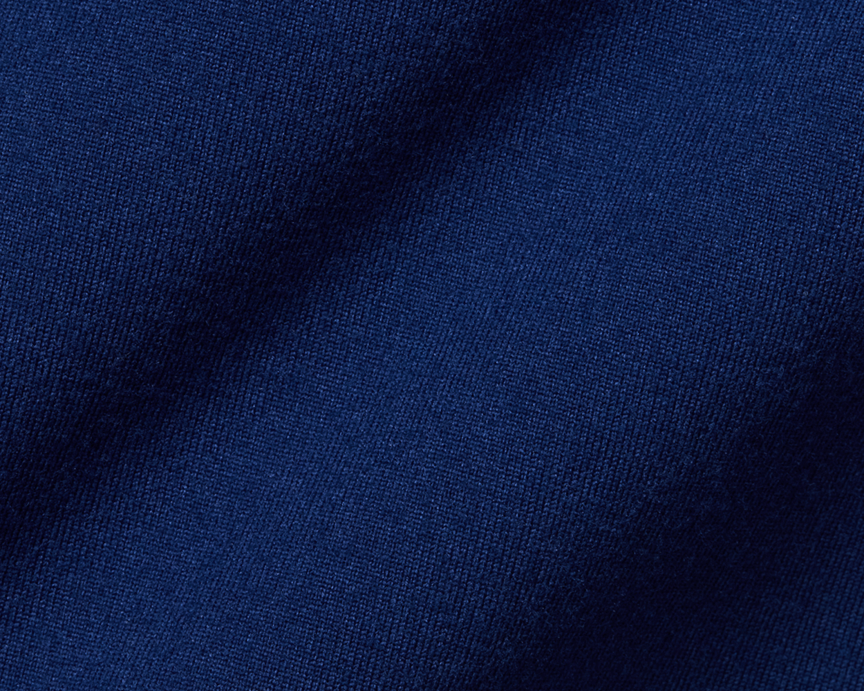 The Jackson Boys Hoodie: Navy, showcasing close-up of soft, dark blue knitted fabric with visible weave texture, highlighting its lightweight, 4-way stretch performance material.