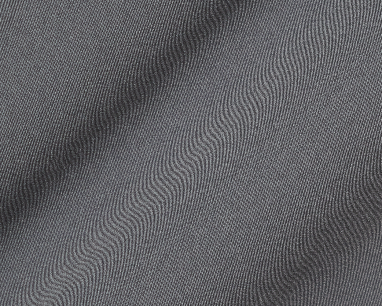 Close-up of The Saunders Short: Iron Gray, showcasing its fine diagonal rib-like texture, gentle folds, and performance fabric designed for stretch and breathability.