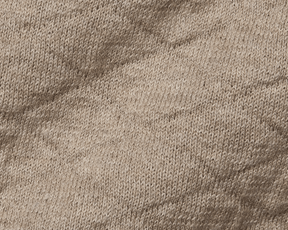 Close-up of The Wallace Hoodie Sweater: Heathered Light Dune, showcasing intricate knit stitches and texture in 100% Egyptian cotton, highlighting its quality and warmth.