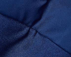 Close-up of The Brodie Jacket: Navy, showcasing dark blue synthetic knit fabric with visible seam, highlighting its technical stretch for comfort and movement.