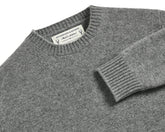 The Berwick Crewneck Sweater: Heathered Gray, folded, featuring medium-weight jersey stitch, ribbed collar and cuff, with label showing Holderness & Bourne – 100% Scottish Cashmere.