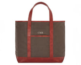 The Travis Tote Bag Cotton Twill: Scotch Green - Rye Embroidery, features a brown canvas with leather trim, monogrammed CMB above a front pocket.