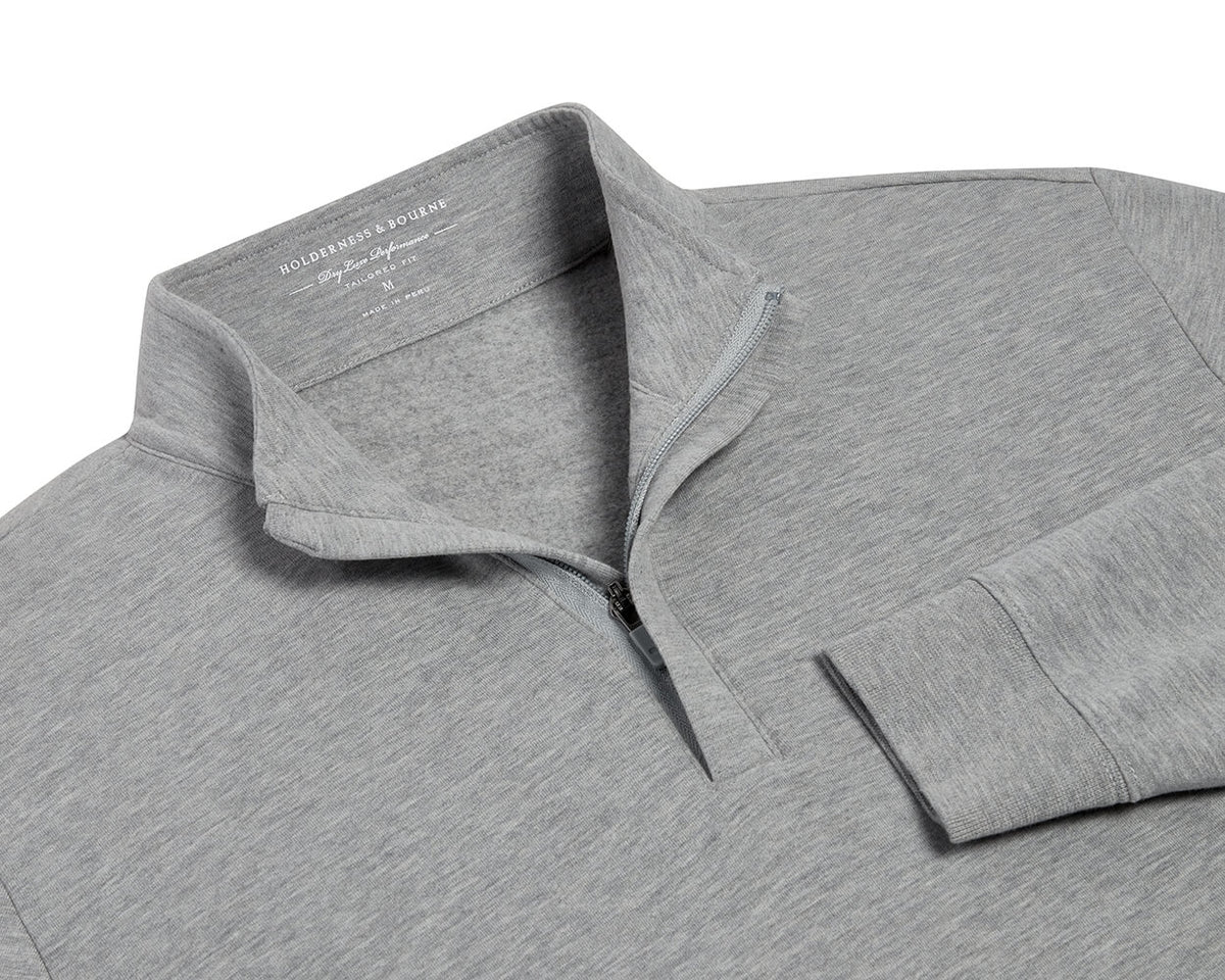 The Harper Quarter-Zip: Heathered Gray pullover features a soft, fleecy interior, standing collar, ribbed cuffs, and a partially open quarter-zip for versatile comfort.