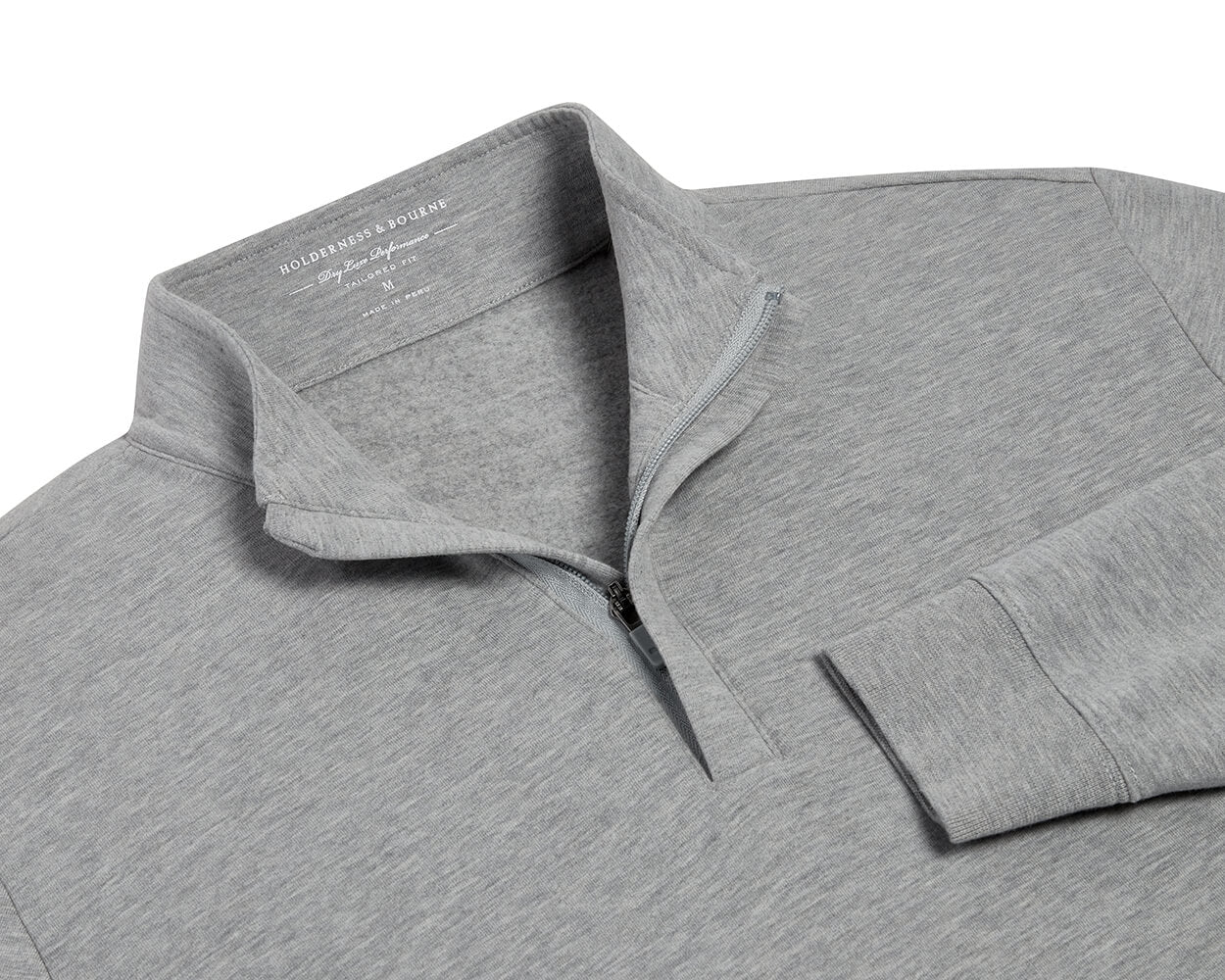 The Harper Quarter-Zip: Heathered Gray pullover features a soft, fleecy interior, standing collar, ribbed cuffs, and a partially open quarter-zip for versatile comfort.