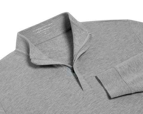 The Harper Quarter-Zip: Heathered Gray pullover features a soft, fleecy interior, standing collar, ribbed cuffs, and a partially open quarter-zip for versatile comfort.
