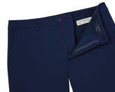 The Harwood Short: Navy men's trousers, laid flat, with open waistband showing Holderness & Bourne, 33 label, emphasizing comfort and golfer-friendly features.