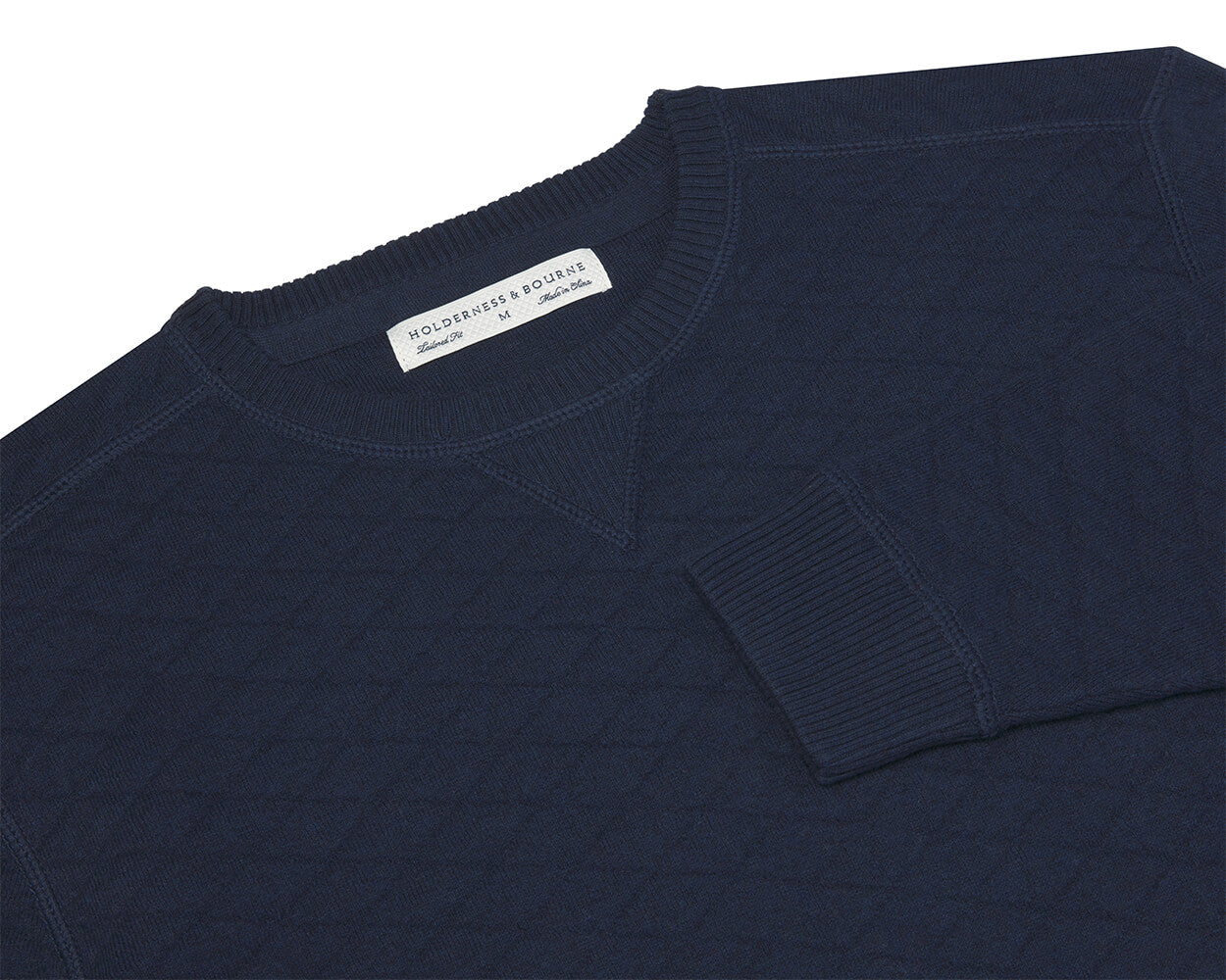 The Ward Crewneck Sweater: Heathered Navy, featuring a quilted-texture and diamond jacquard knit, showcases a woven label “HOLDERNESS & BOURNE,” size M.