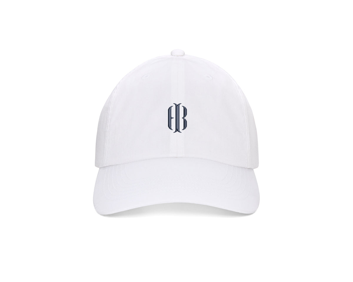 The Lightweight Cotton Hat: White with HB Icon features a gothic monogram on the front, low profile, adjustable closure, and UPF 50+ protection.