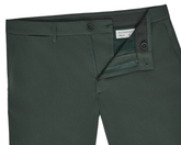 The Harwood Short: Ivy, showcasing front view with belt loops, button closure, zip fly, slash pockets, and visible inside waistband with label.
