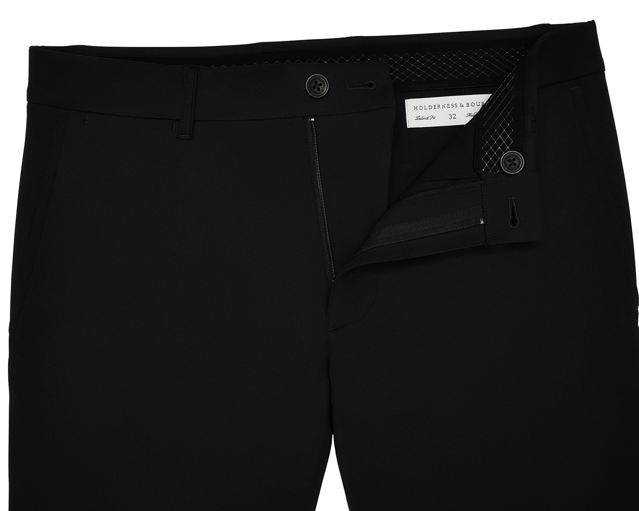 The Harwood Short: Black, displayed with a partly open zipper and undone button, revealing a Holderness & Bourne label and size 32 inside the waistband.