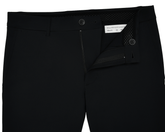 The Harwood Short: Black, displayed with a partly open zipper and undone button, revealing a Holderness & Bourne label and size 32 inside the waistband.