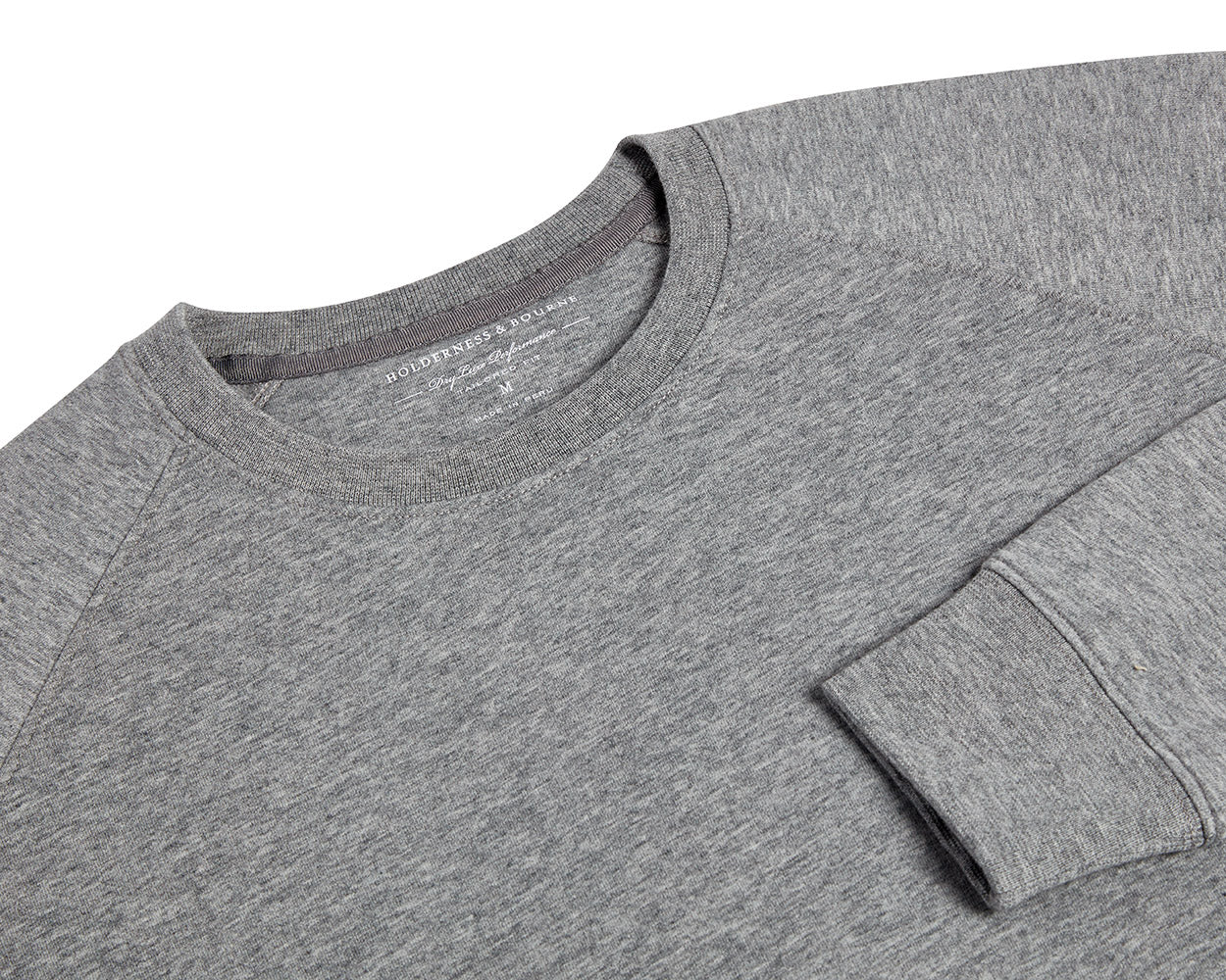 The Kennedy Crewneck: Heathered Gray, featuring a crew-neck design with visible collar, shoulder seams, and cuff, crafted from a soft cotton blend with terry interior.