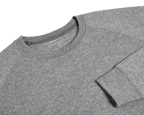 The Kennedy Crewneck: Heathered Gray, featuring a crew-neck design with visible collar, shoulder seams, and cuff, crafted from a soft cotton blend with terry interior.