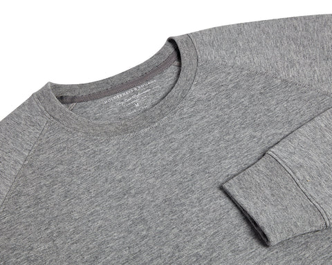 The Kennedy Crewneck: Heathered Gray, featuring a crew-neck design with visible collar, shoulder seams, and cuff, crafted from a soft cotton blend with terry interior.