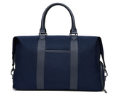 The Byers Duffel Bag: Navy Ballistic, featuring sturdy fabric, leather handles, vertical front straps, and a zippered side pocket, ideal for travel with easy-access top opening.