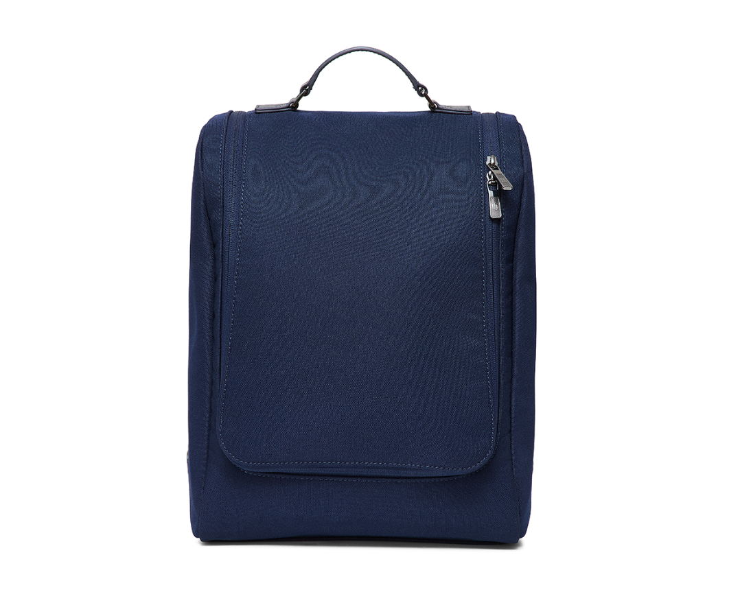 The Rutledge Shoe Bag: Navy Ballistic, featuring a top handle, front zip flap, and leather trim, ideal for protecting and organizing shoes during travel.