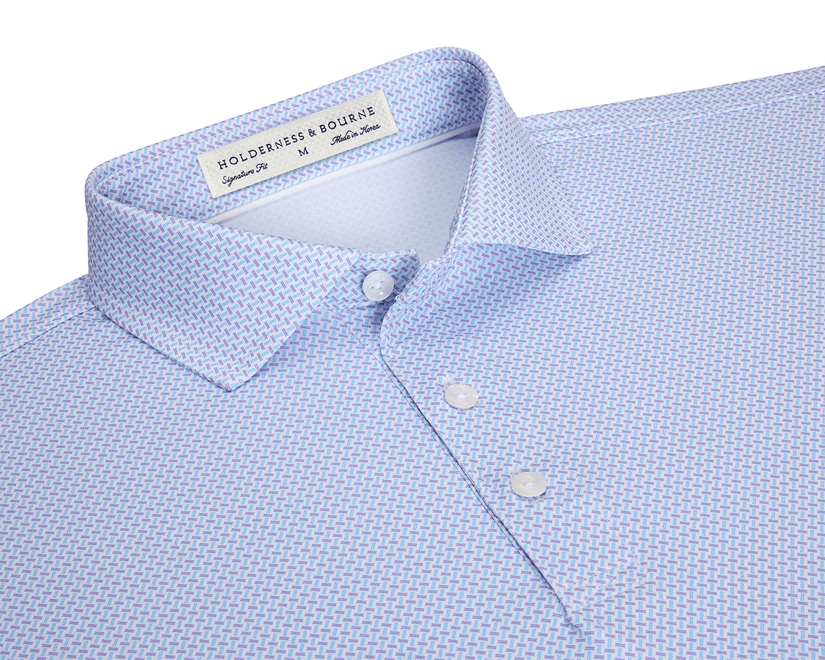The Norman Shirt: Vista Blue & Tudor, featuring a spread collar, white buttons, and a light blue crosshatch pattern, highlighted by a HOLDERNESS & BOURNE label.