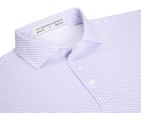The Geiger Shirt: Tudor features a lavender-purple motif on white fabric, showcasing its spread collar and three-button placket, emphasizing Holderness & Bourne's signature fit.
