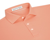 The Macdonald Shirt: Nectarine, a medium-sized polo with a structured collar, three-button placket, and contrast piping, offering breathable comfort and a modern style.