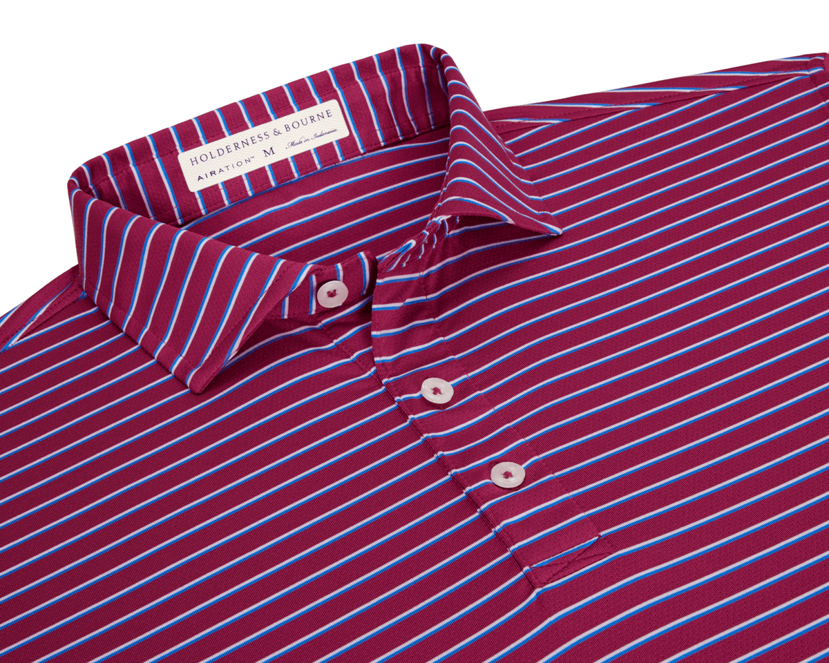 The Springer Shirt: Cabernet/White/Horizon Blue features a burgundy knit with sky-blue and white stripes, three-button placket, and fold-over collar, showcasing AIRATION® fabric.