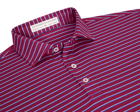 The Springer Shirt: Cabernet/White/Horizon Blue features a burgundy knit with sky-blue and white stripes, three-button placket, and fold-over collar, showcasing AIRATION® fabric.