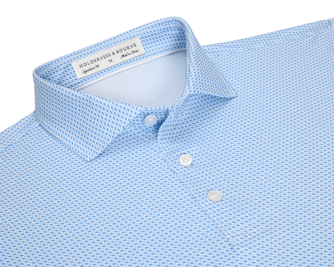 The Norman Shirt: Vista Blue & Horizon Blue, featuring a micro-textured dash pattern, spread collar, and white buttons, with performance jersey for comfort and UV protection.