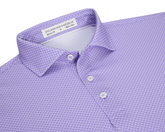 The Eaton Shirt: Tudor, a lavender-purple men’s polo with geometric texture, features a spread collar, three-button placket, and is designed for warm-weather performance.
