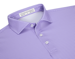 The Eaton Shirt: Tudor, a lavender-purple men’s polo with geometric texture, features a spread collar, three-button placket, and is designed for warm-weather performance.
