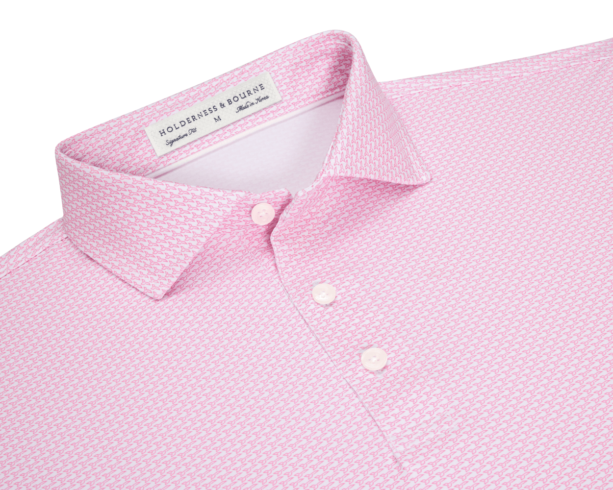 The Hanover Shirt: Belmont, a light pink polo with a geometric pattern, features a three-button placket, spread collar, and signature fit label inside.