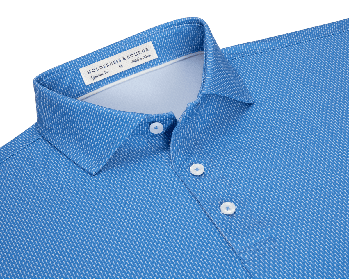 The Hicks Shirt: Horizon Blue, featuring a geometric white dash pattern, three-button placket, and structured collar. Offers moisture wicking, breathability, and UPF 50+ protection.