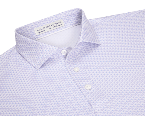 The Fulton Shirt: Vista Blue & Tudor, a men's button-up with a purple line-drawing pattern, classic spread collar, and white buttons, laid flat.