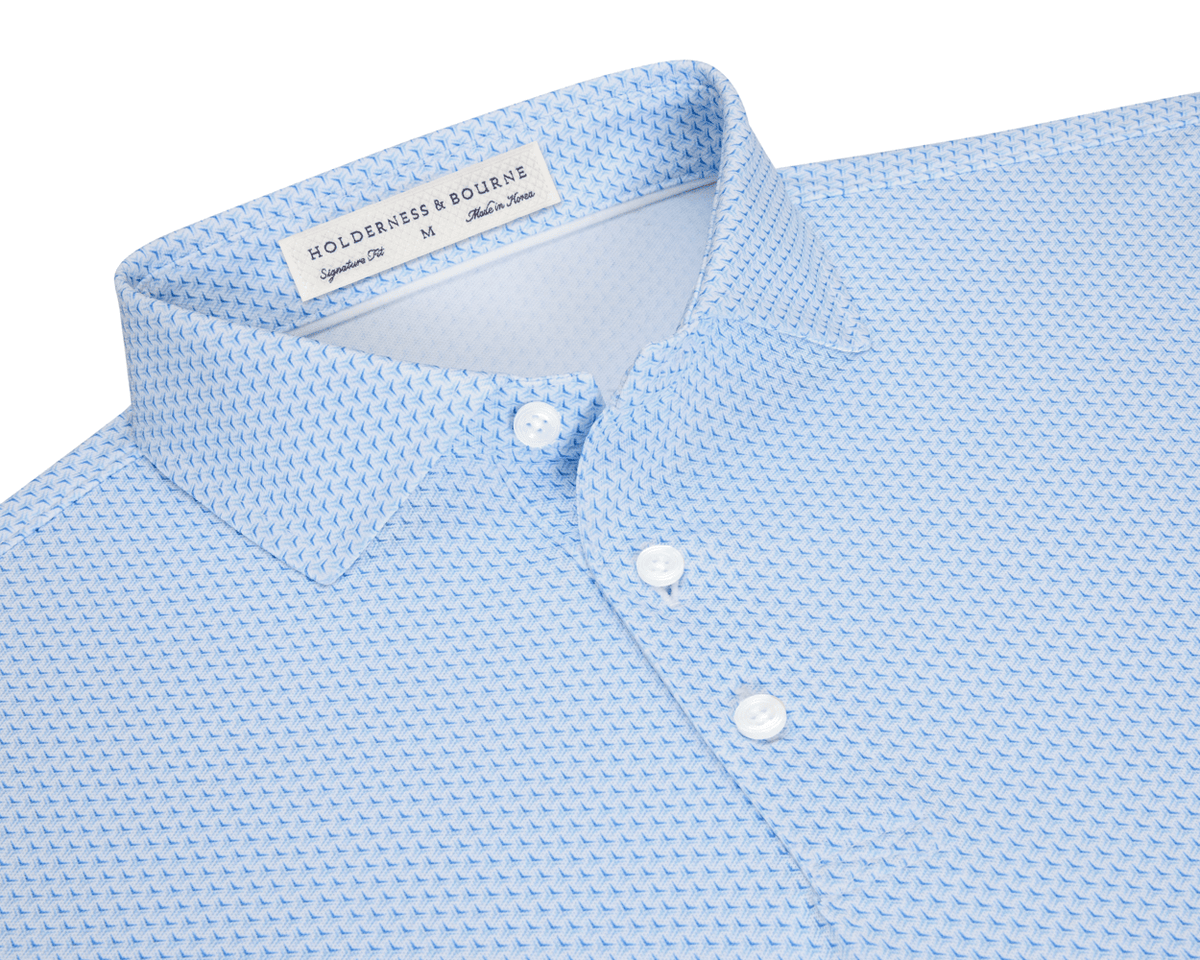 The Lennox Shirt: Vista Blue & Horizon Blue, featuring a geometric pattern, spread collar, and three-button placket, offers breathable comfort and UPF 30+ protection.