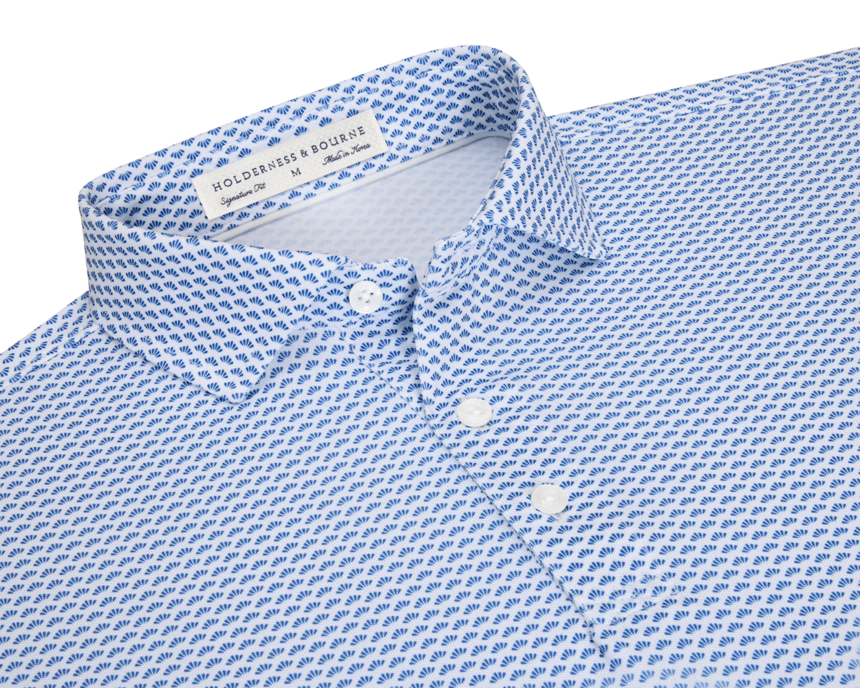 The Geiger Shirt: Maidstone Blue features a white collared design with a blue scallop motif, showcasing its breathable, moisture-wicking performance pique and structured spread collar.