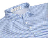 The Geiger Shirt: Maidstone Blue features a white collared design with a blue scallop motif, showcasing its breathable, moisture-wicking performance pique and structured spread collar.