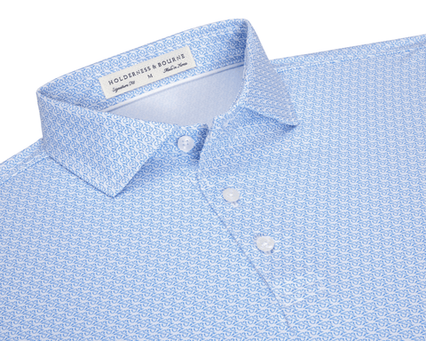 The Griffin Shirt: Horizon Blue, featuring a subtle griffin pattern, three-button placket, and a structured spread collar, crafted for comfort with moisture-wicking and UPF 50+ fabric.