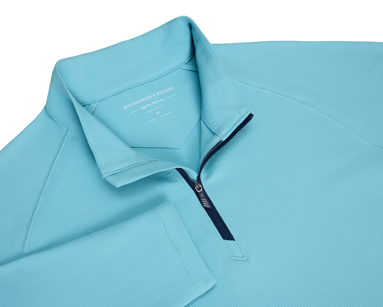 The Stuart Quarter-Zip: Harbor features a ribbed-texture, long-sleeve design with a navy zipper and standing collar, showcasing Holderness & Bourne branding inside the neck.