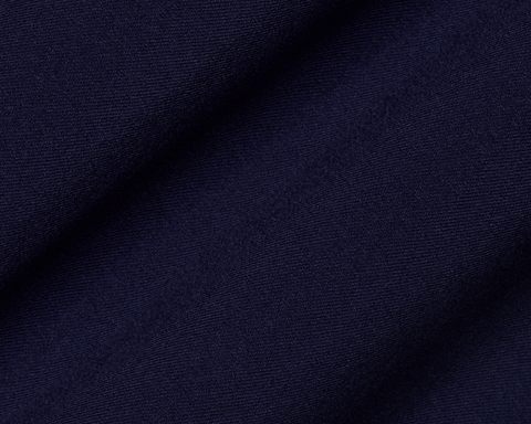 Close-up of The Anson Chino Pant: Navy, showcasing its fine woven texture and draping, highlighting the eco-friendly, wrinkle-resistant, and water-repellent fabric with four-way stretch.