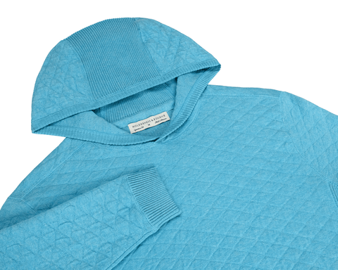 The Wallace Hoodie Sweater: Heathered Harbor, a quilted hoodie with diamond patterns, ribbed cuffs, and hood trim, crafted from textured knit Egyptian cotton.