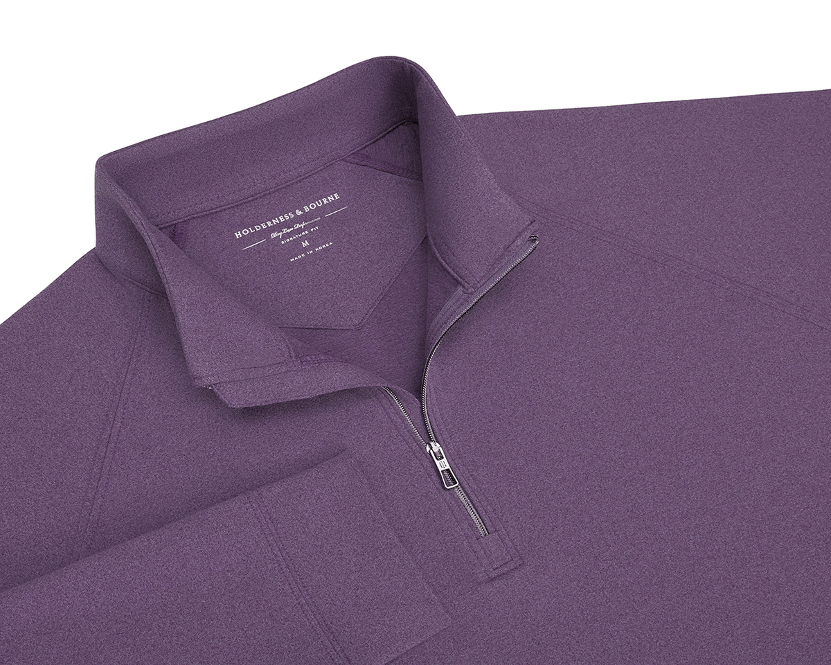 The Westland Quarter-Zip: Heathered Amherst features a stand-up collar, metal zipper, and soft, moisture-wicking fabric, perfect for versatile wear.