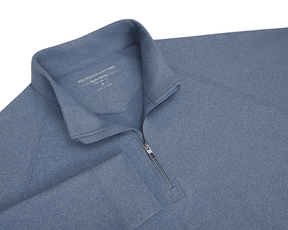 The Westland Quarter-Zip: Heathered Andover displayed with a stand-up collar, quarter-length zipper, and visible Holderness & Bourne branding on soft, heathered slate-blue knit fabric.