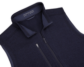 The Ashby Vest: Heathered Dark Navy by Holderness & Bourne, featuring a zip-up design, zippered chest pocket, and brushed interior for comfort and style.