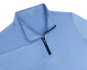 The Royce Quarter-Zip: Heathered Horizon Blue features light-blue pin-stripes, a navy quarter-zip, and a soft collar, ideal for versatile layering.