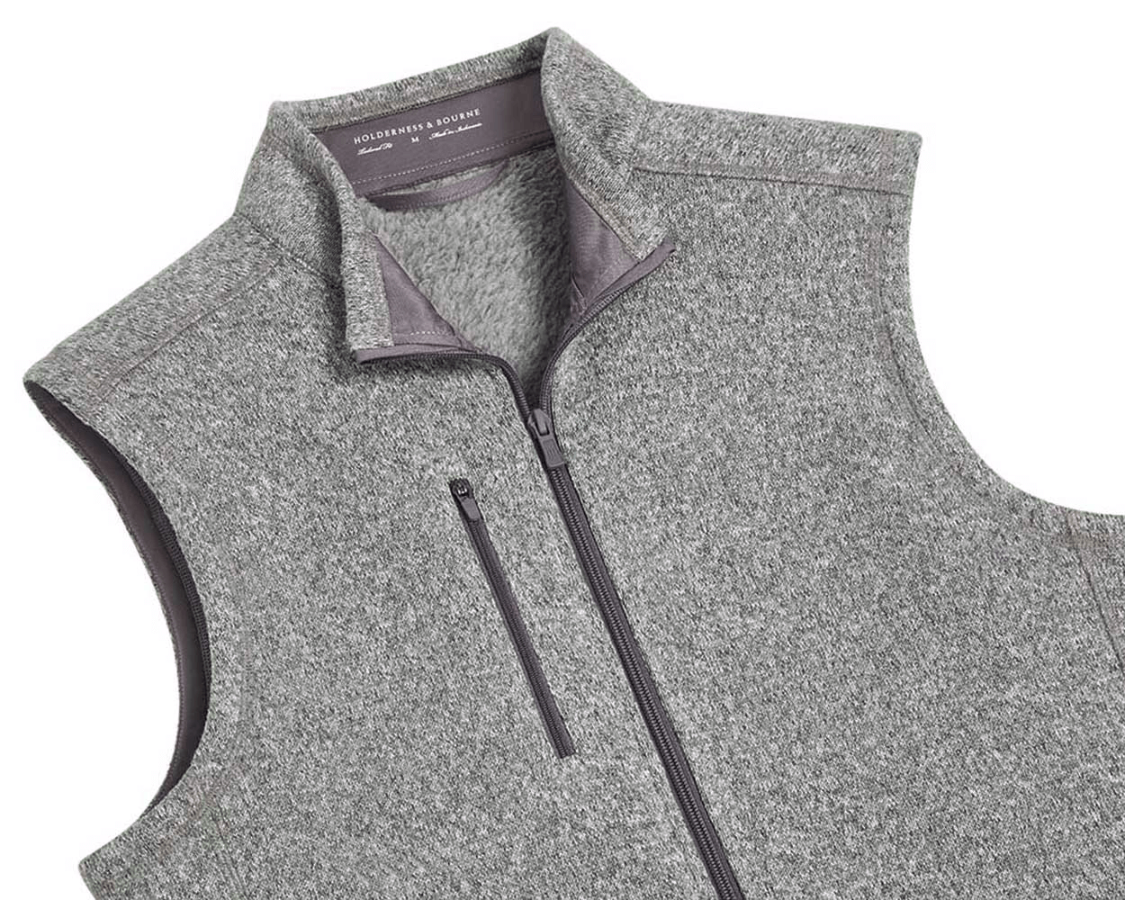 The Ashby Vest: Heathered Gray men's sleeveless zip-up with stand-up collar, zippered chest pocket, and tonal accents. Features a buttery soft interior and H&B embroidery.