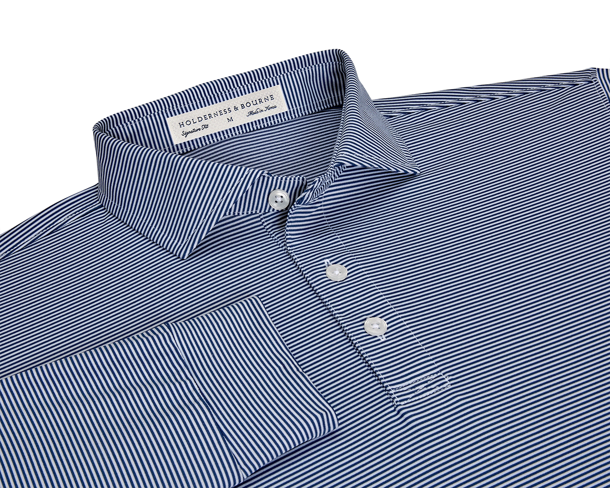 The Burke Shirt: Navy & White, folded long-sleeve polo with fine stripes, features a button-down placket, structured collar, and Holderness & Bourne tag.